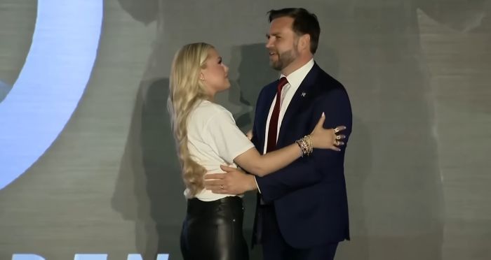 Erika Kirk hugging country singer on stage in a formal setting amid public attention and viral moments.