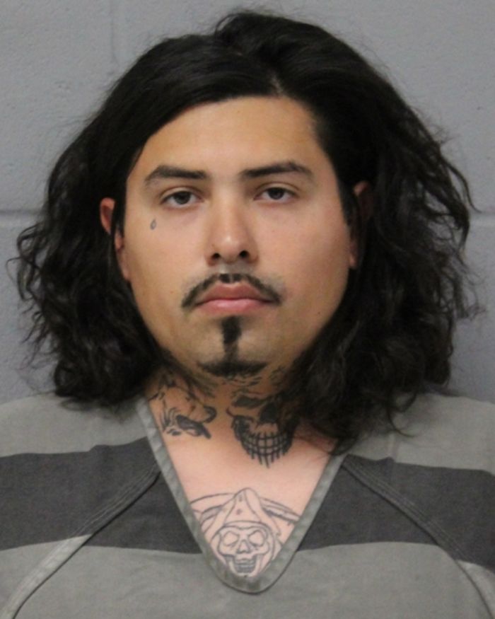 Mugshot of a man with long dark hair and tattoos, linked to woman found chained in backyard in bizarre case.