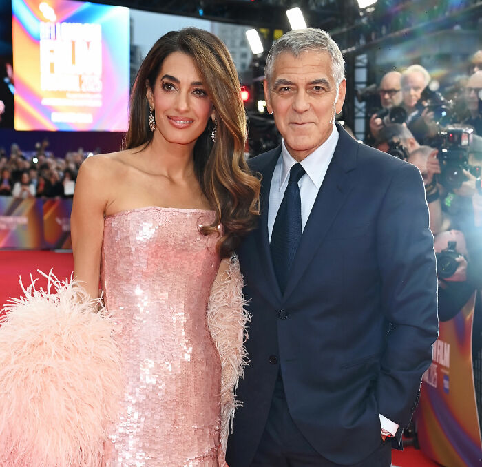 Amal Clooney and George Clooney on red carpet amid major Photoshop blunder and Vogue editing controversy.