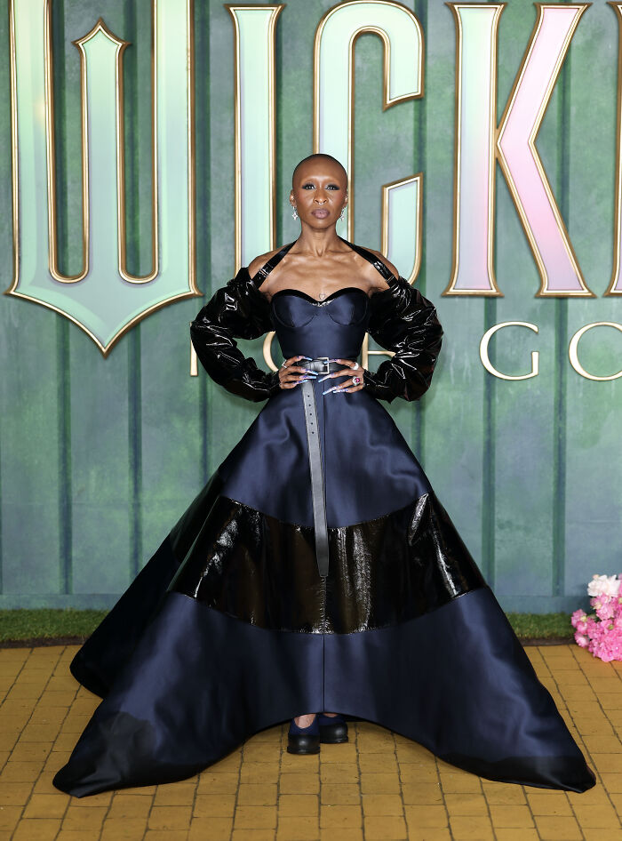 Star in a bold black gown with leather details and puffed sleeves at the Wicked For Good London premiere red carpet.
