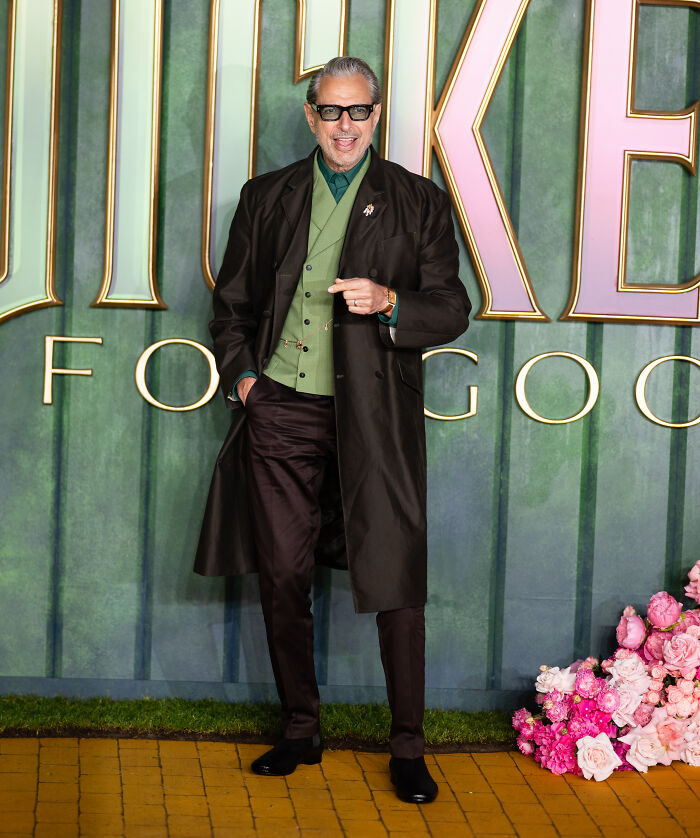 Actor Jeff Goldblum wearing a green vest and black coat on the Wicked: For Good London premiere red carpet.