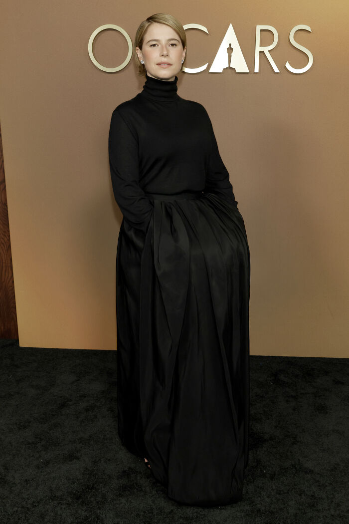 Woman in a black high-neck gown posing at the 2025 Governors Awards showcasing notable fashion disasters.