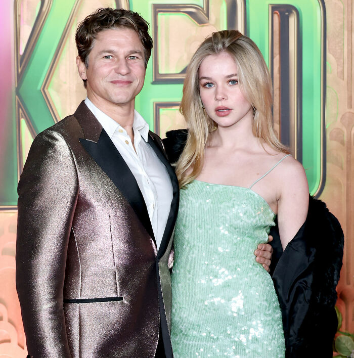 Neil Patrick Harris with daughter Harper, 15, posing at the Wicked premiere, showcasing her grown-up look in a green dress.