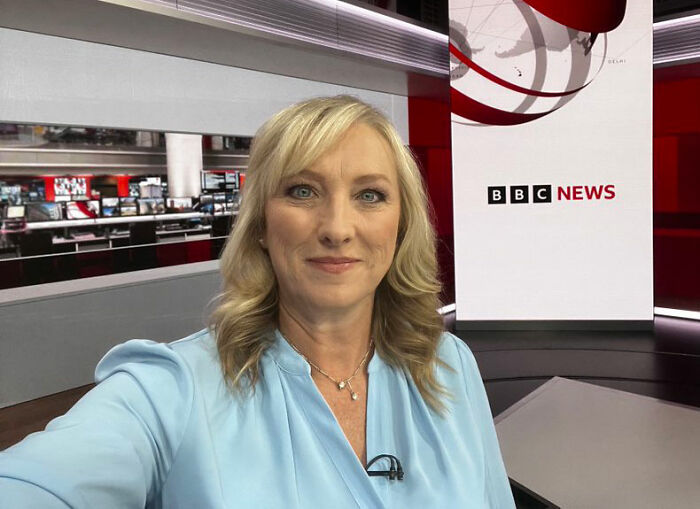 BBC anchor in a newsroom wearing a blue shirt, associated with news on discipline related to trans remarks on-air.