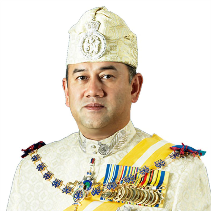 Portrait of Malaysia&rsquo;s ex-king wearing traditional royal attire with medals and a cream-colored decorative hat.