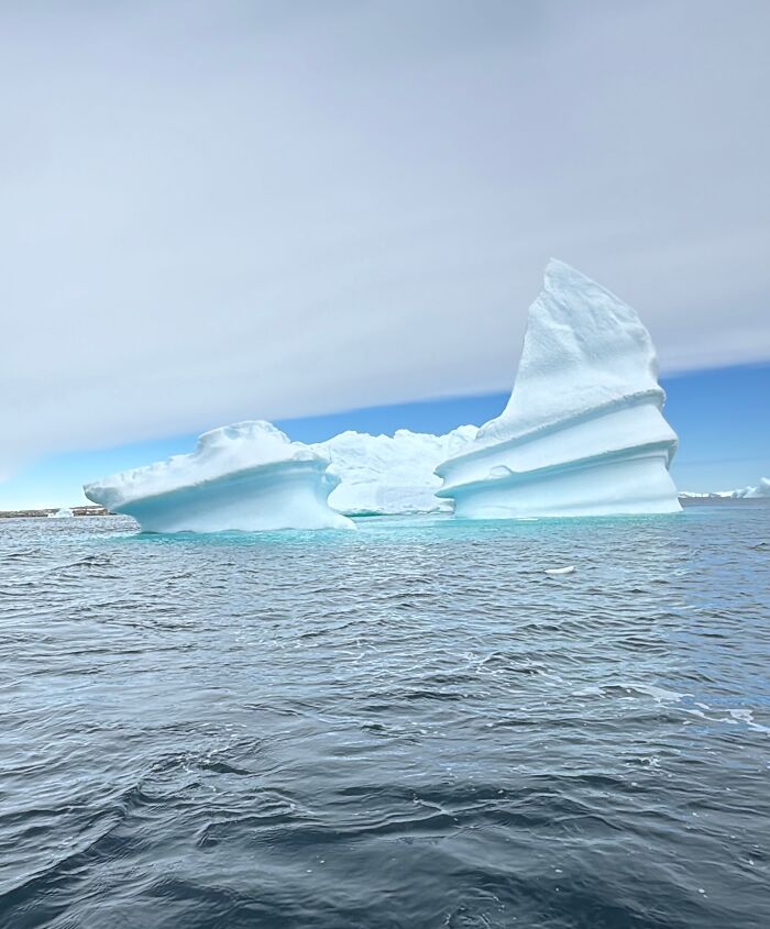 Massive iceberg floating in icy waters showcasing the scale and beauty of Antarctica's natural landscape. Massive iceberg floating in icy waters showcasing the scale and beauty of Antarctica's natural landscape.