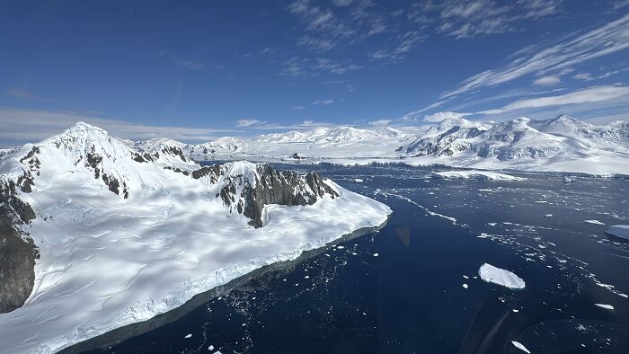 Snow-covered mountains and icy waters showcasing the scale and beauty of Antarctica during an unforgettable adventure. Snow-covered mountains and icy waters showcasing the scale and beauty of Antarctica during an unforgettable adventure.
