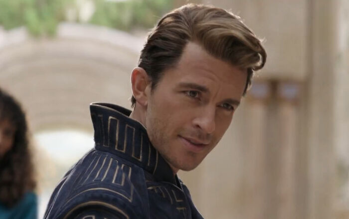 Jonathan Bailey wearing a patterned jacket, looking off camera in a scene sparking buzz as sexiest man alive.
