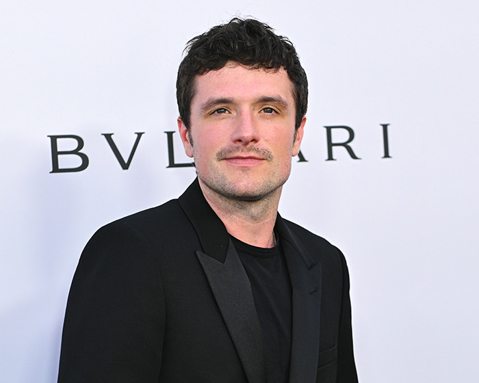 Actor in a black jacket posing at an event, representing celebrities who made stunning confessions about their movies.