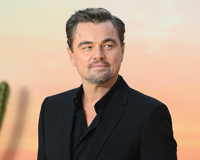 Actor wearing a black suit and shirt, making stunning confessions about their movies years after filming.