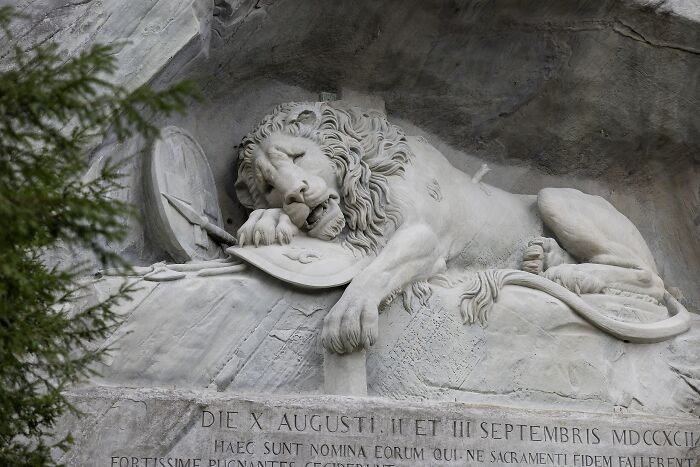 Marble lion sculpture carved into rock, an iconic spectacular sculpture popular on global travel bucket lists.
