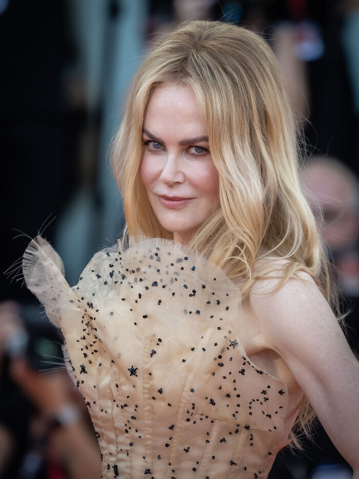 Blonde style icon wearing a beaded beige dress at a glamorous event, showcasing fashion that inspires mood boards.