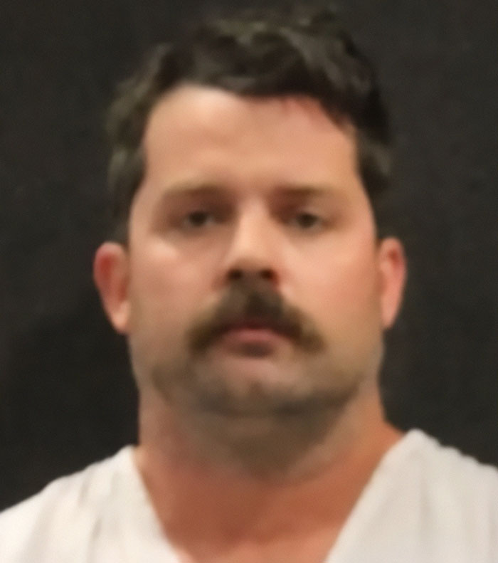 Blurry mugshot of a man with mustache, related to teen unsurprised her dad took his life after leaving 2-year-old in hot car.