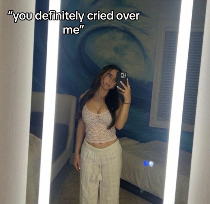 Stunning woman taking a mirror selfie indoors wearing light clothing, related to viral Georgia-Texas game reactions.