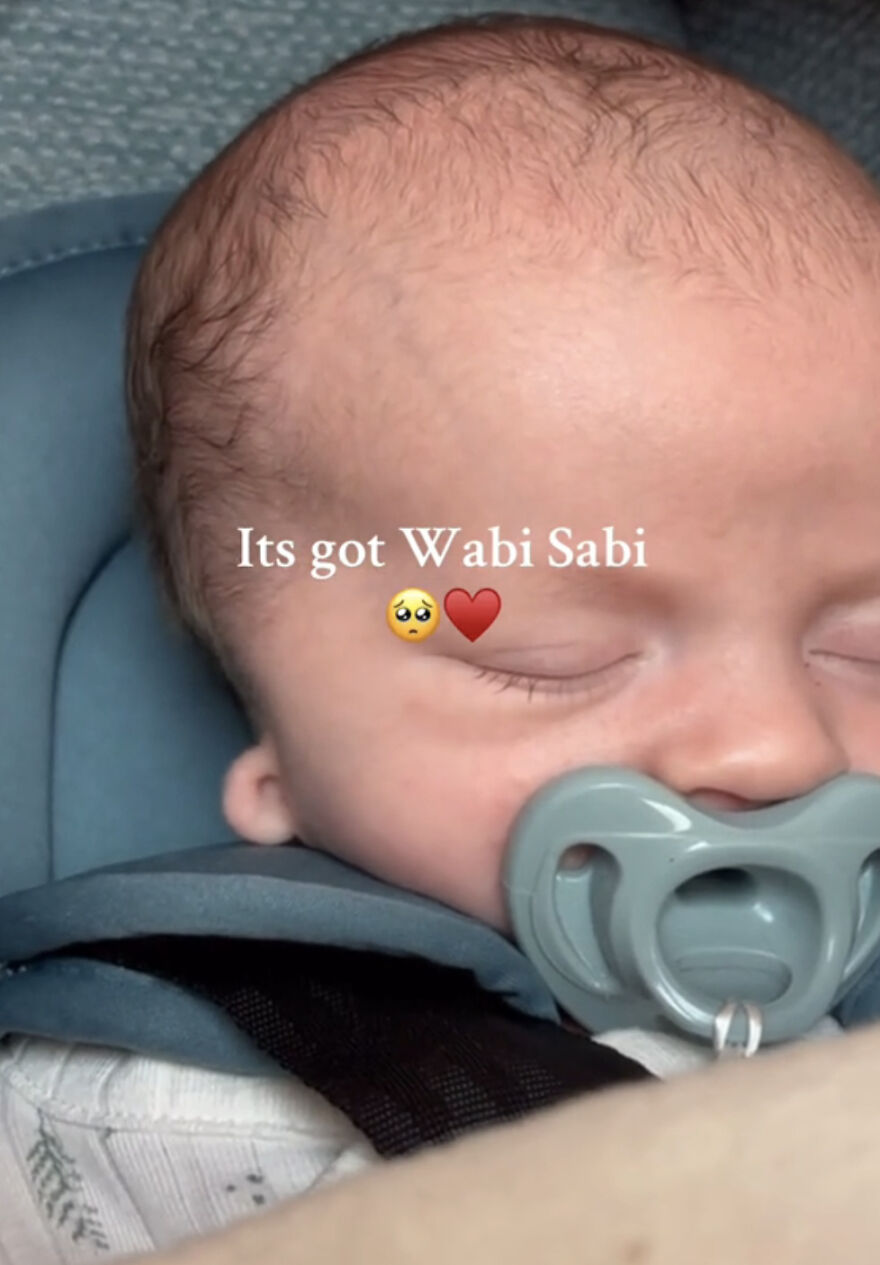 Sleeping baby with pacifier illustrating people proudly sharing their perfect imperfections in a wholesome trend.