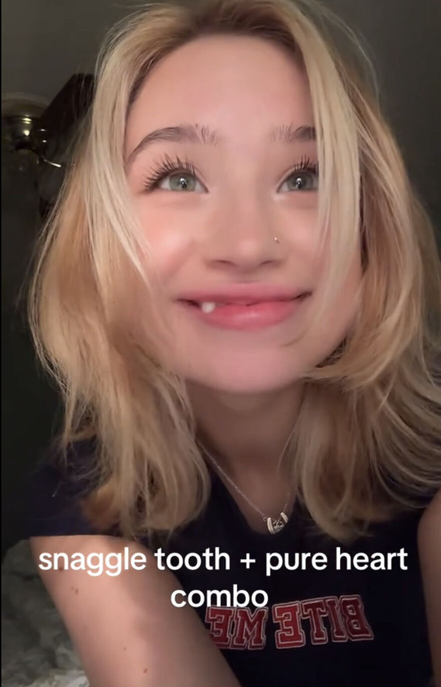Young woman with snaggle tooth smiling happily, embracing perfect imperfections in a wholesome trend.