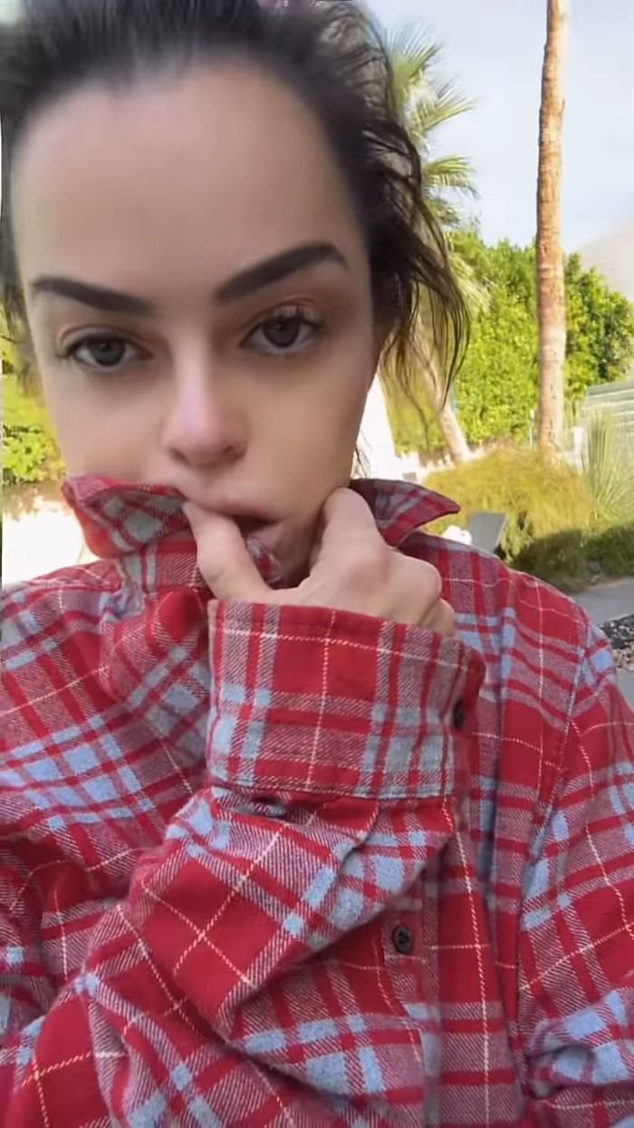 Taryn Manning wearing a red plaid shirt outdoors, with fans worried after a bizarre video appearance.