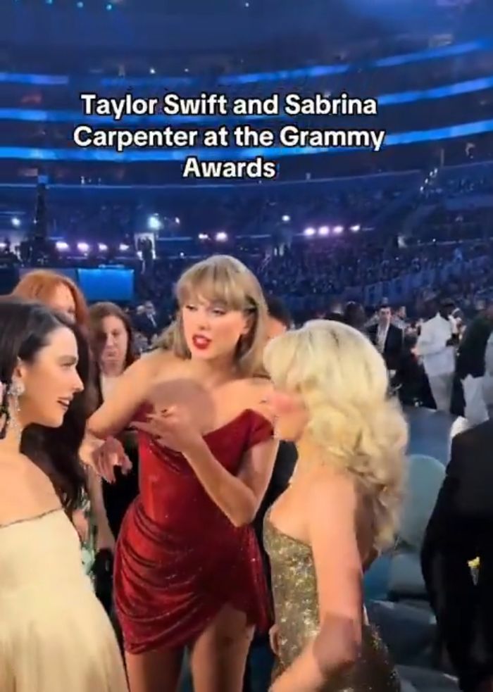 Taylor Swift speaking animatedly with Sabrina Carpenter at the Grammy Awards amid a crowded venue, sparking manners debate.