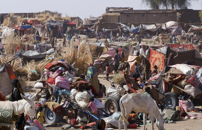 Crowded settlement scene showing people and donkeys amid makeshift shelters highlighting the poorest country and hardship faced.