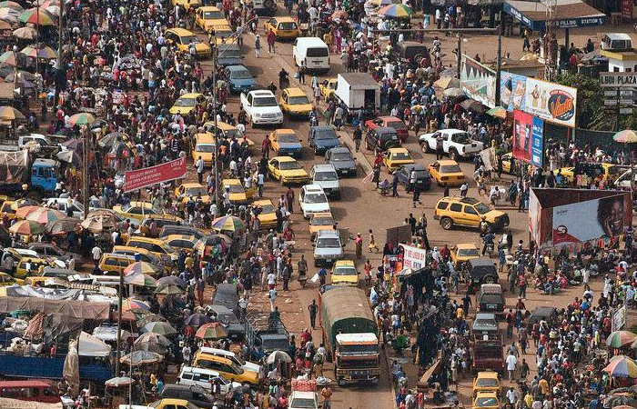 Crowded urban street filled with people and vehicles, illustrating challenges in the poorest country and others facing hardship.