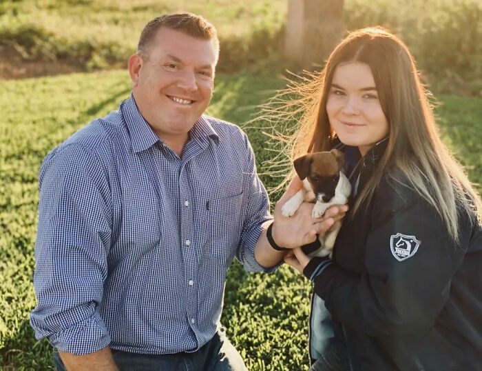 Politician and daughter outdoors holding a puppy, illustrating a personal family moment amid adult content creator revelation.