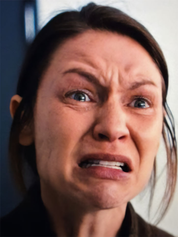 Claire Danes in a close-up showing a quivering chin and distressed expression in a scene from her new hit show.