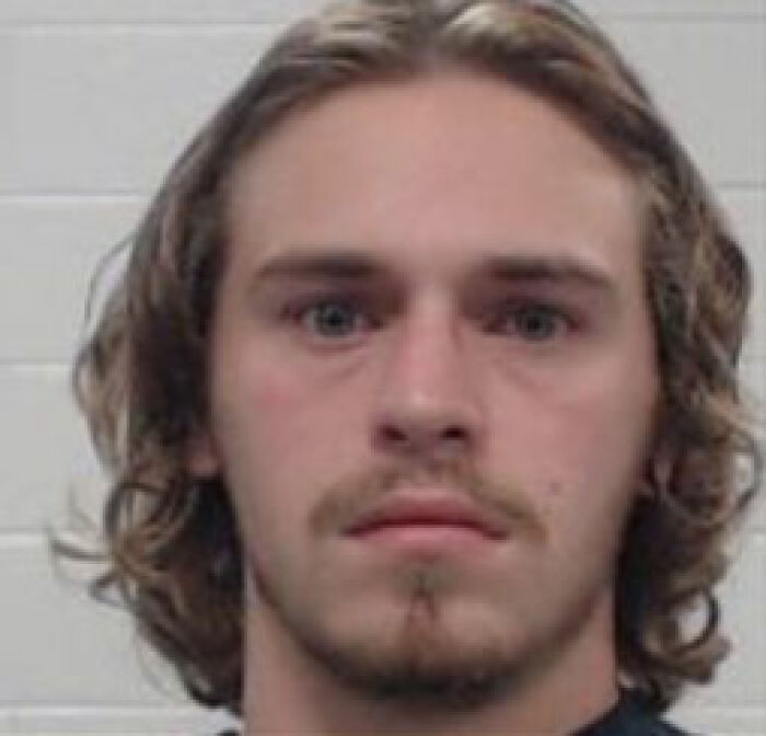 Mugshot of a young man involved in plan to sail to foreign island with intent to execute men and enslave women and kids.