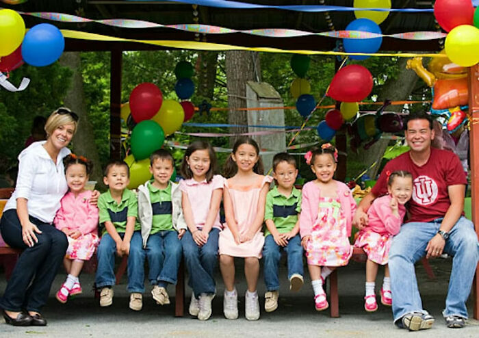Family gathered under colorful balloons and streamers celebrating a joyful occasion, symbolizing new beginnings and remarriage. Family gathered under colorful balloons and streamers celebrating a joyful occasion, symbolizing new beginnings and remarriage.
