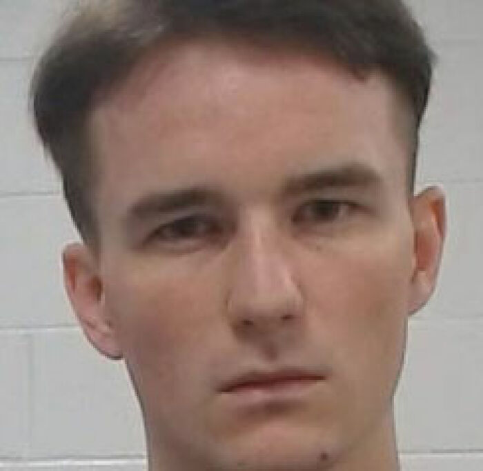 Mugshot of a man arrested over plan to sail to foreign island involving e*******n and enslavement of women and kids.