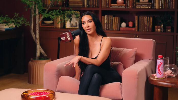 A woman speaking into a mic during a podcast, illustrating examples of the butterfly effect happening in real life.