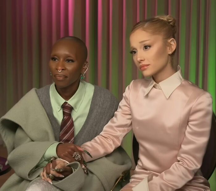 Cynthia Erivo and Ariana Grande dressed elegantly during an interview highlighting their new bizarre interaction.