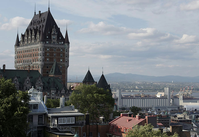 View of historic buildings and waterfront in Canada, highlighting American expats' observations in Canadian cityscape.