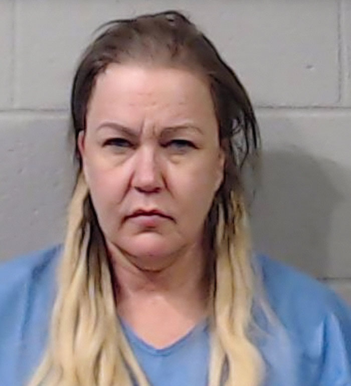 Mugshot of a woman with blonde hair wearing a blue shirt related to former news anchor case involving her mother.