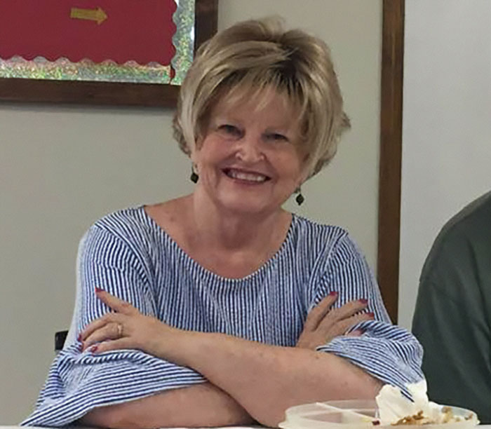 Former news anchor smiling and sitting at a table, related to former news anchor takes her own mother's life story.