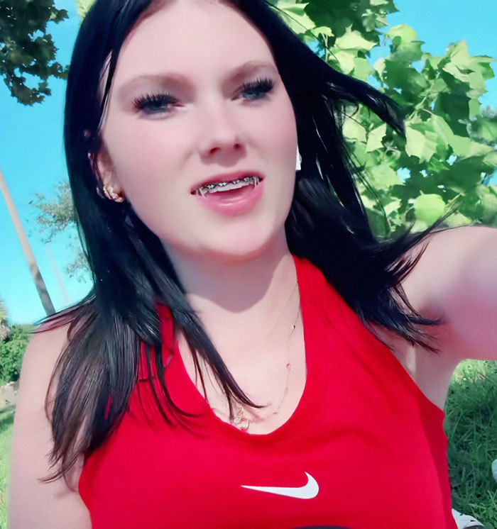 Teen in red shirt with braces outdoors, related to stepbrother obsession case in a cruise incident, according to ex reveals.