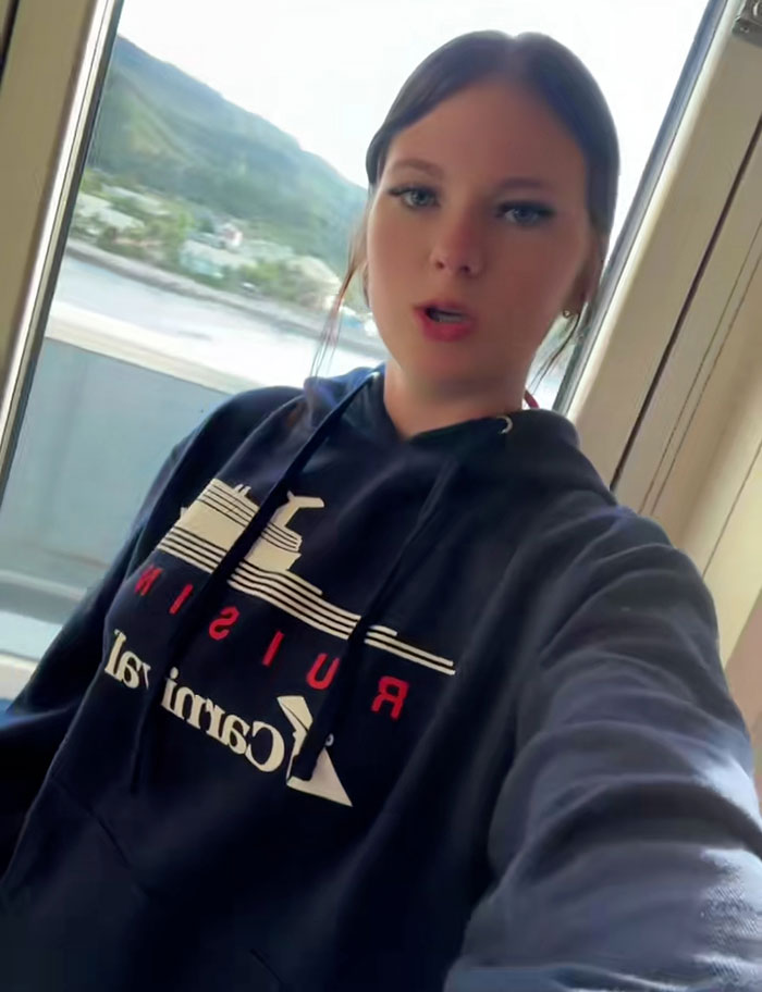 Teen wearing cruise hoodie near window with water and hills, related to stepbrother obsessed with her disturbing details case.