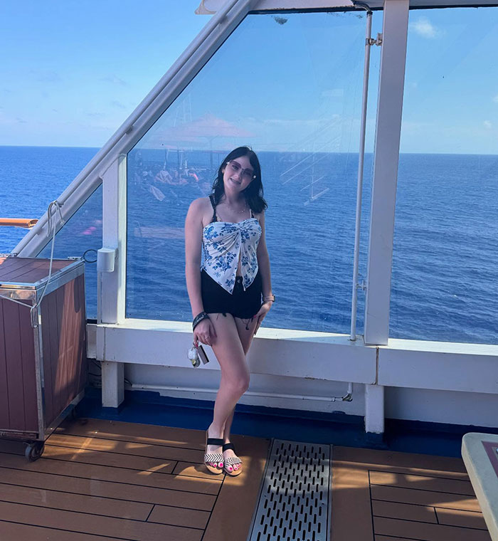 Teen on Carnival cruise ship deck with ocean background related to stepsibling investigation after body found under bed