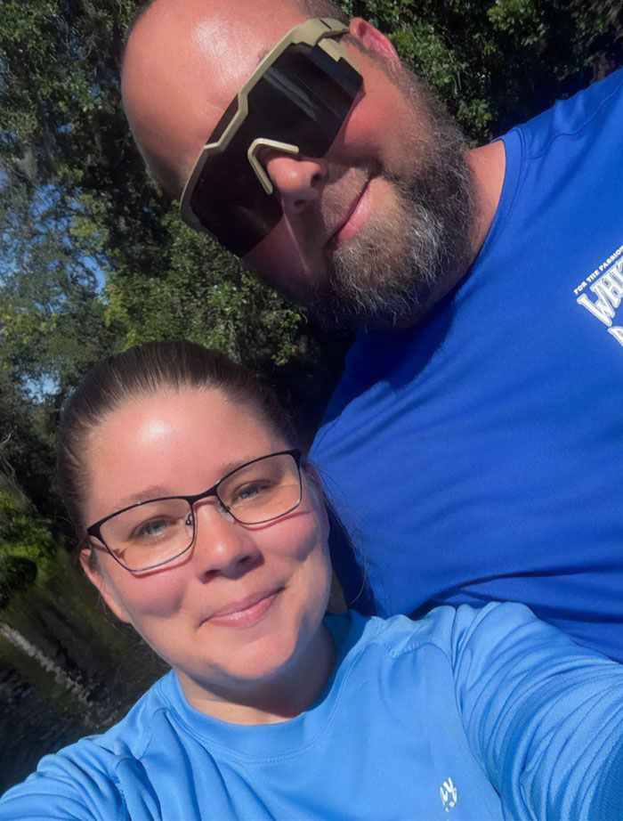 Man and woman outdoors, both wearing blue shirts, with stepbrother of teen slain in cruise mentioned in the context.