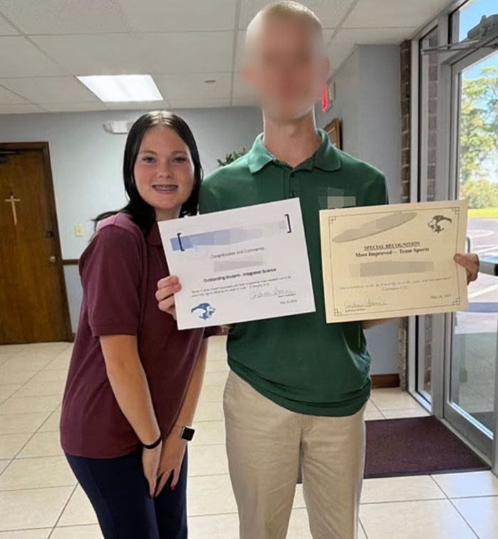 Teen girl and boy holding certificates indoors, related to father of teen slain on cruise and alleged affair with babysitter.