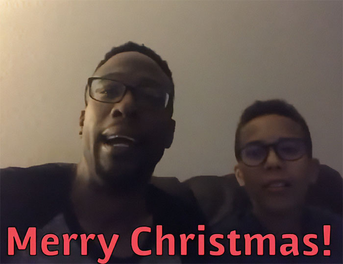 Two males wearing glasses sitting together with Merry Christmas text, related to celebrity chef dark side case.