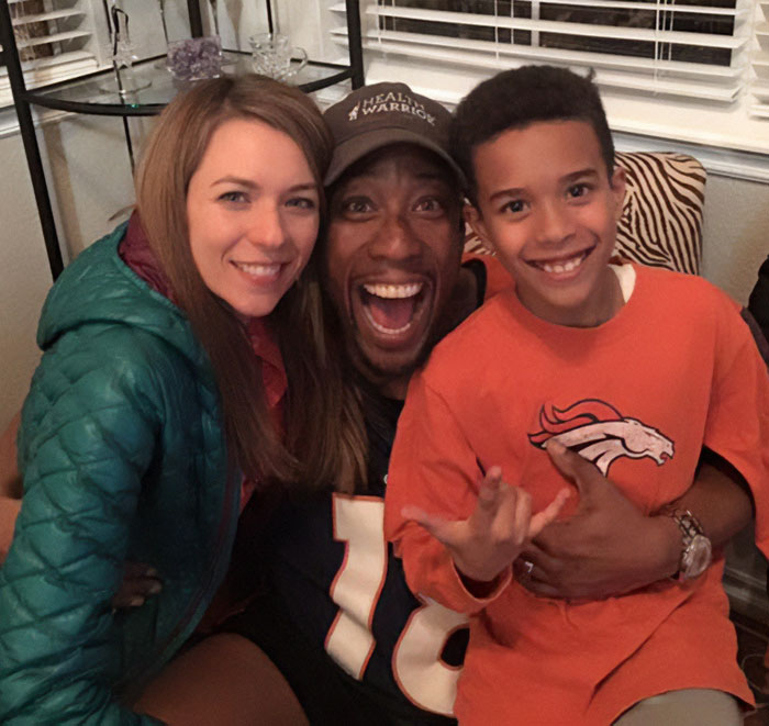 Happy family posing together indoors, unrelated to celebrity chef dark side slaying news story.