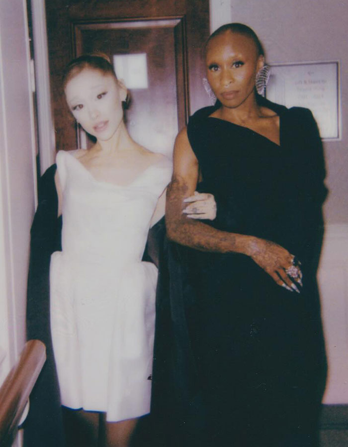 Ariana Grande and a friend dressed elegantly during the Wicked press tour revealing Ariana Grande diagnosis news.