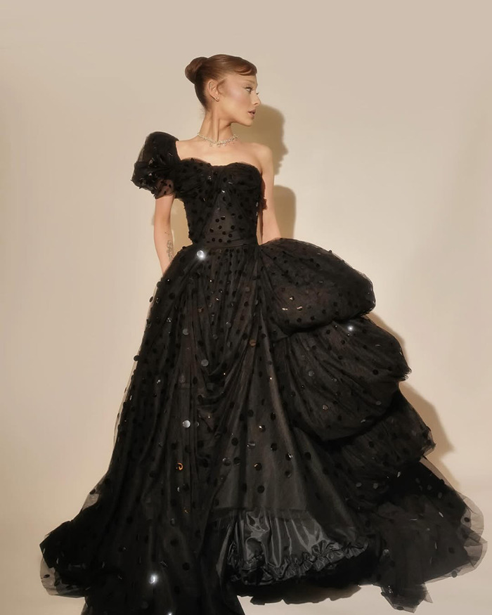 Ariana Grande wearing a dramatic black gown, fans express concern over her Wicked role affecting her deeply.