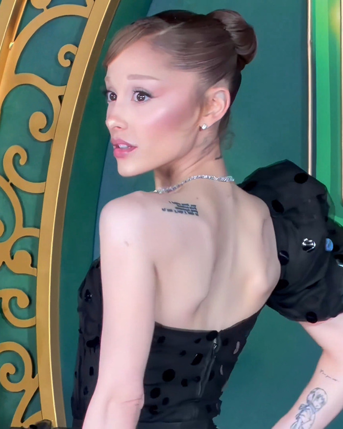 Ariana Grande in black dress with updo hairstyle, fans concerned Wicked role is impacting her appearance and energy.