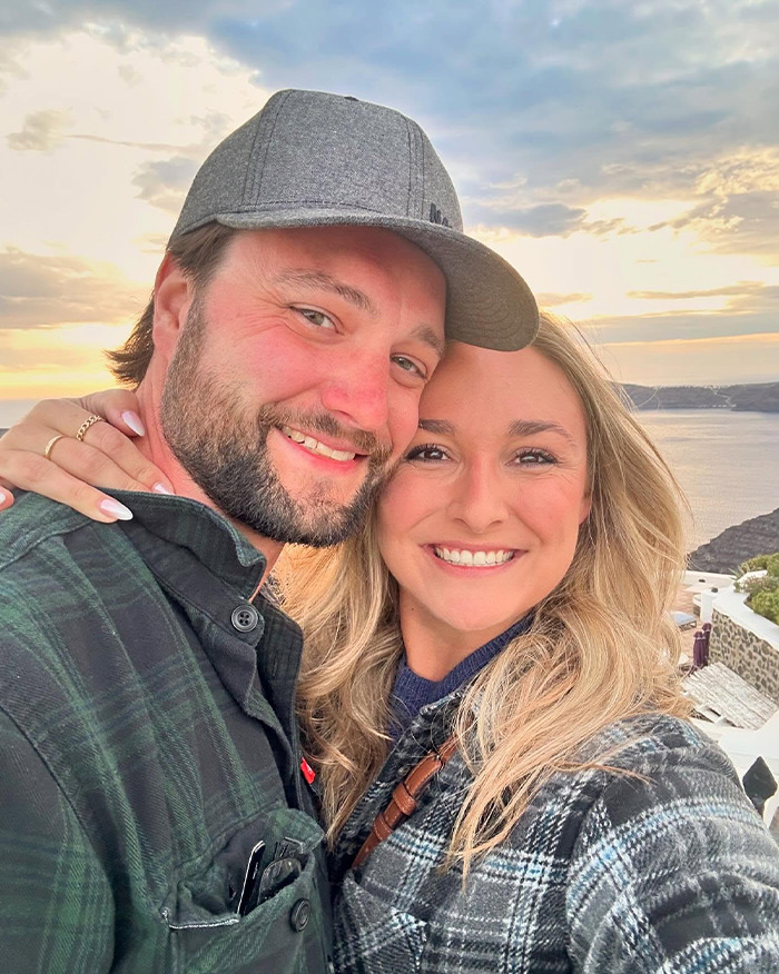 Newlywed couple smiling during sunset with scenic coastal background, linked to autopsy revealing chilling truth.