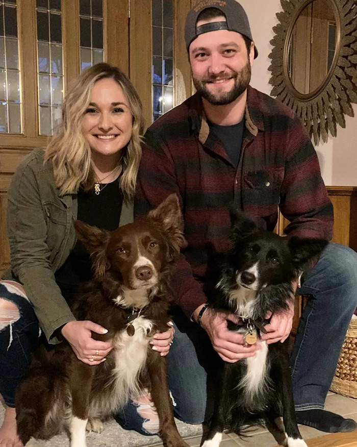 Newlywed couple posing indoors with two dogs, highlighting the chilling truth revealed by an autopsy report.