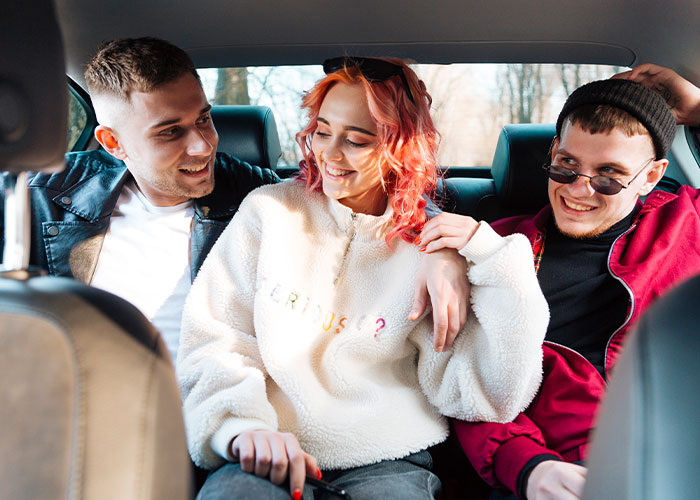 Three friends sharing a funny moment inside a car, capturing crazy moments that weren’t what they looked like