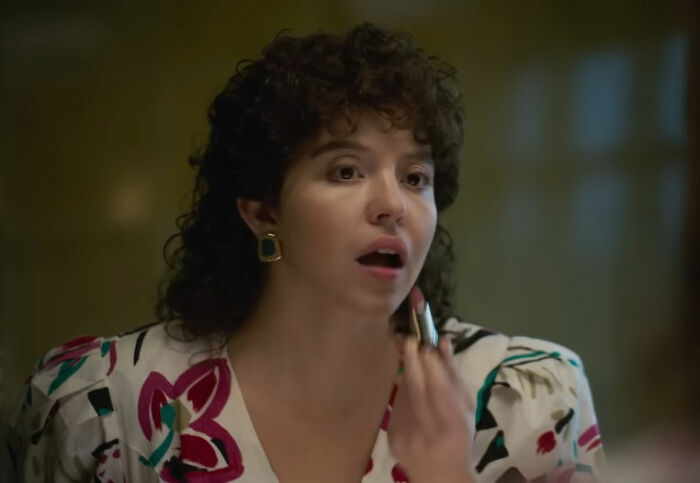 Sydney Sweeney applying makeup in a floral top, related to leaked PR emails and damage control after Christy box office results.