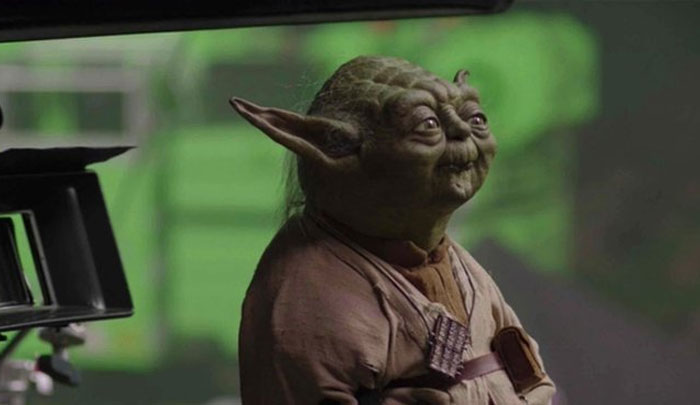 Behind-the-scenes photo of Yoda puppet on set, showing unhinged moment that became a meme waiting to happen.