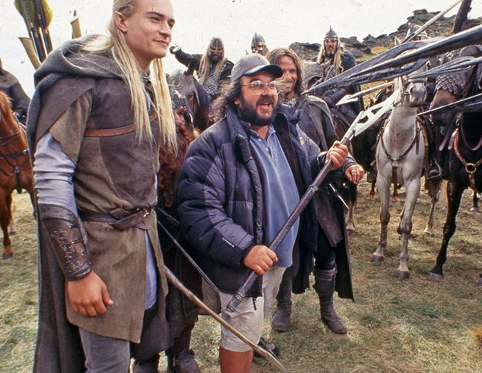 Behind-the-scenes photo of a medieval movie set with actors and crew laughing, perfect for unhinged meme moments.